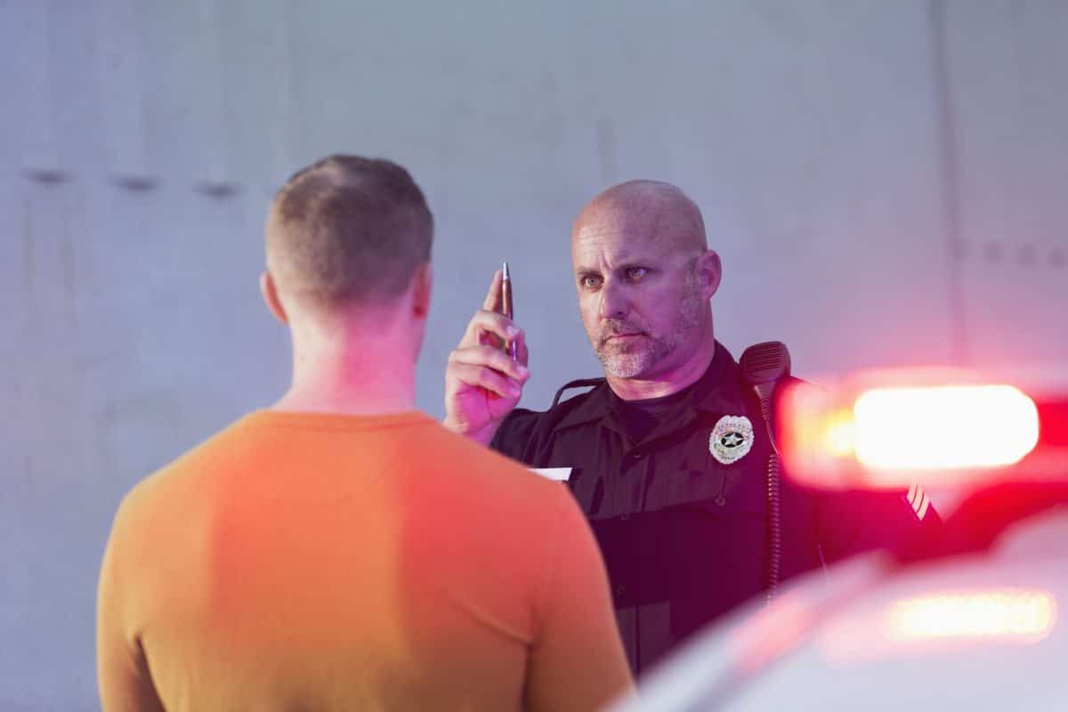 A policeman conducting a sobriety test.