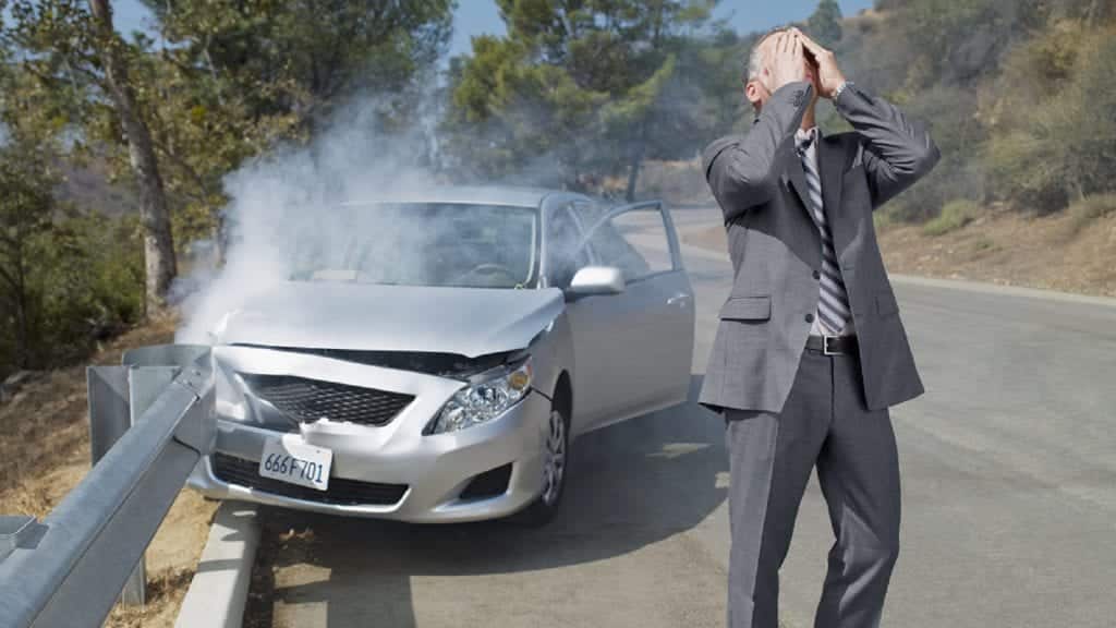 Frustrated Man Standing Beside A Wrecked Car Stock Photo