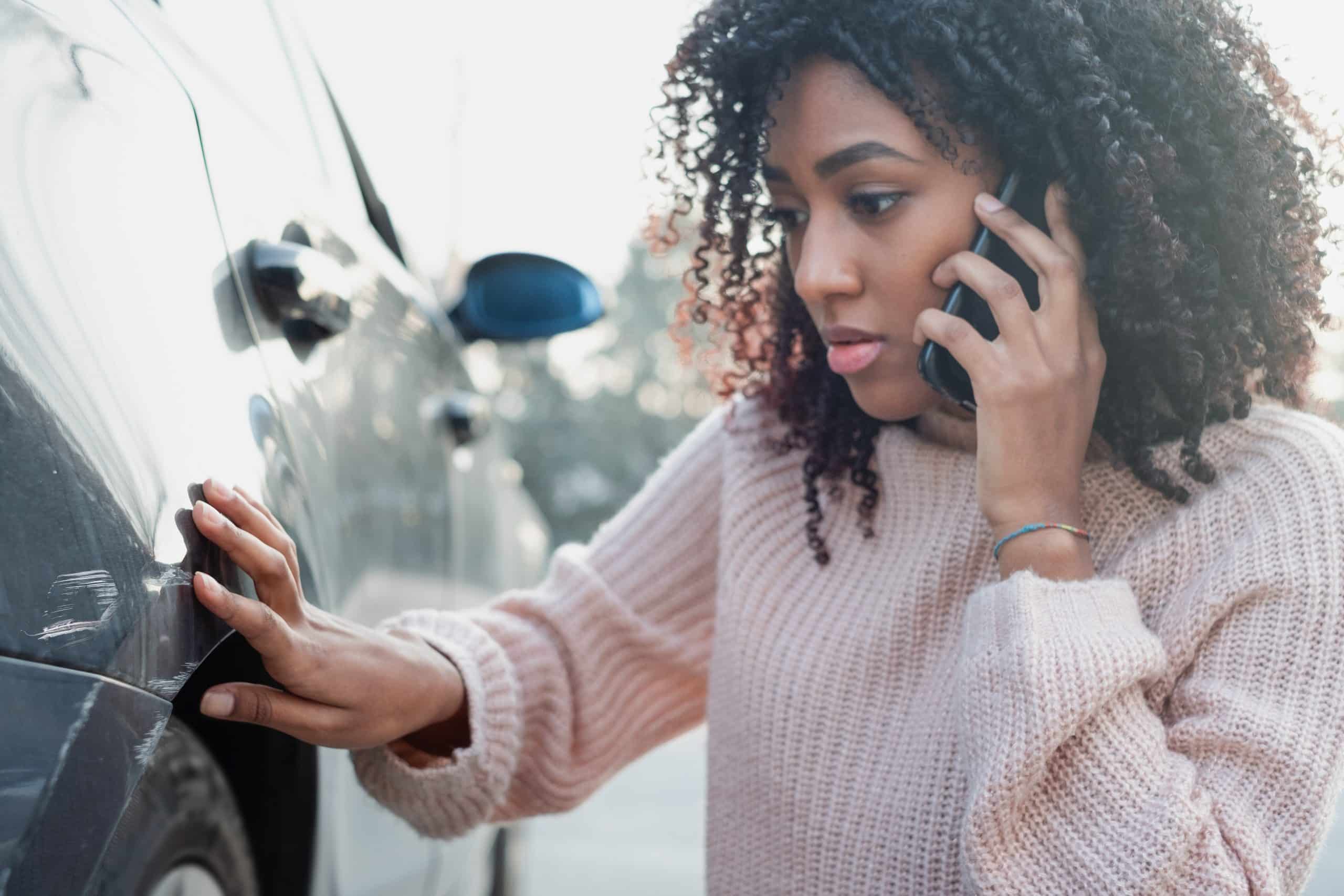 woman calling a car accident lawyer after an accident