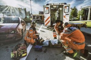 a man receiving medical treatment after a car crash in Mobile, AL