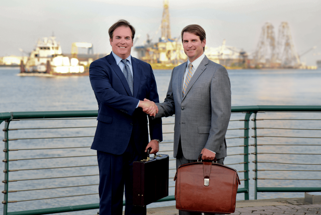 Attorneys Earle and Bennett Long shaking hands in Mobile, AL