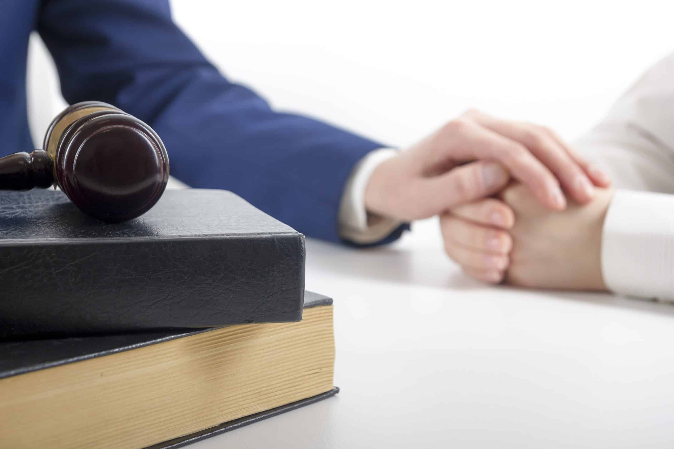 Wrongful death lawyer in Orange Beach puts their hand on their client’s hands to comfort them.