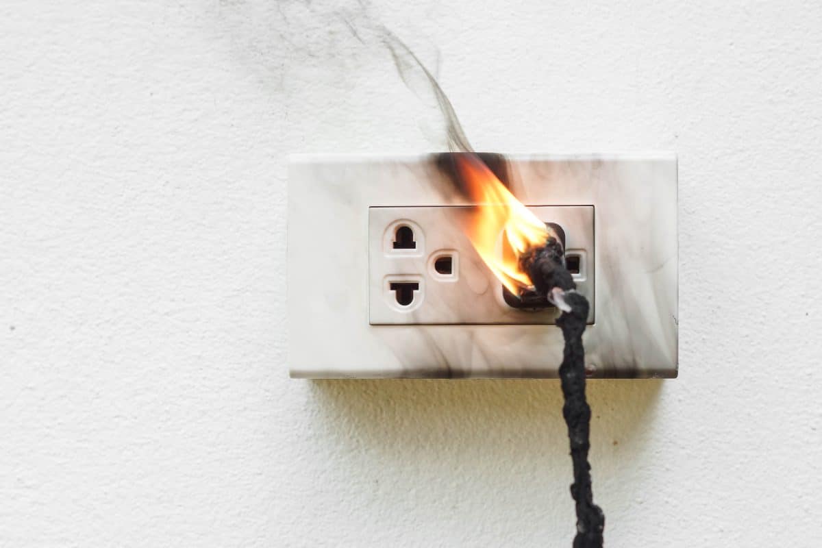A defective plug short-circuits in the socket, causing the cord to catch on fire.