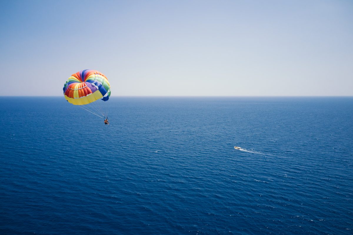 Aerial view of a parasailor over a large body of water.